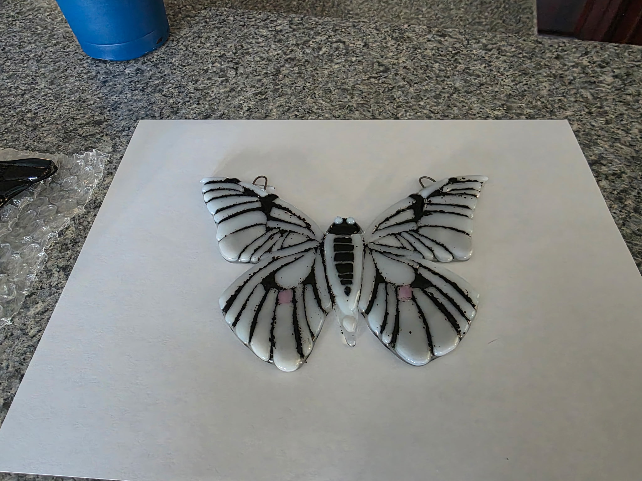 White and black striped fused glass butterfly pendant with pink dots